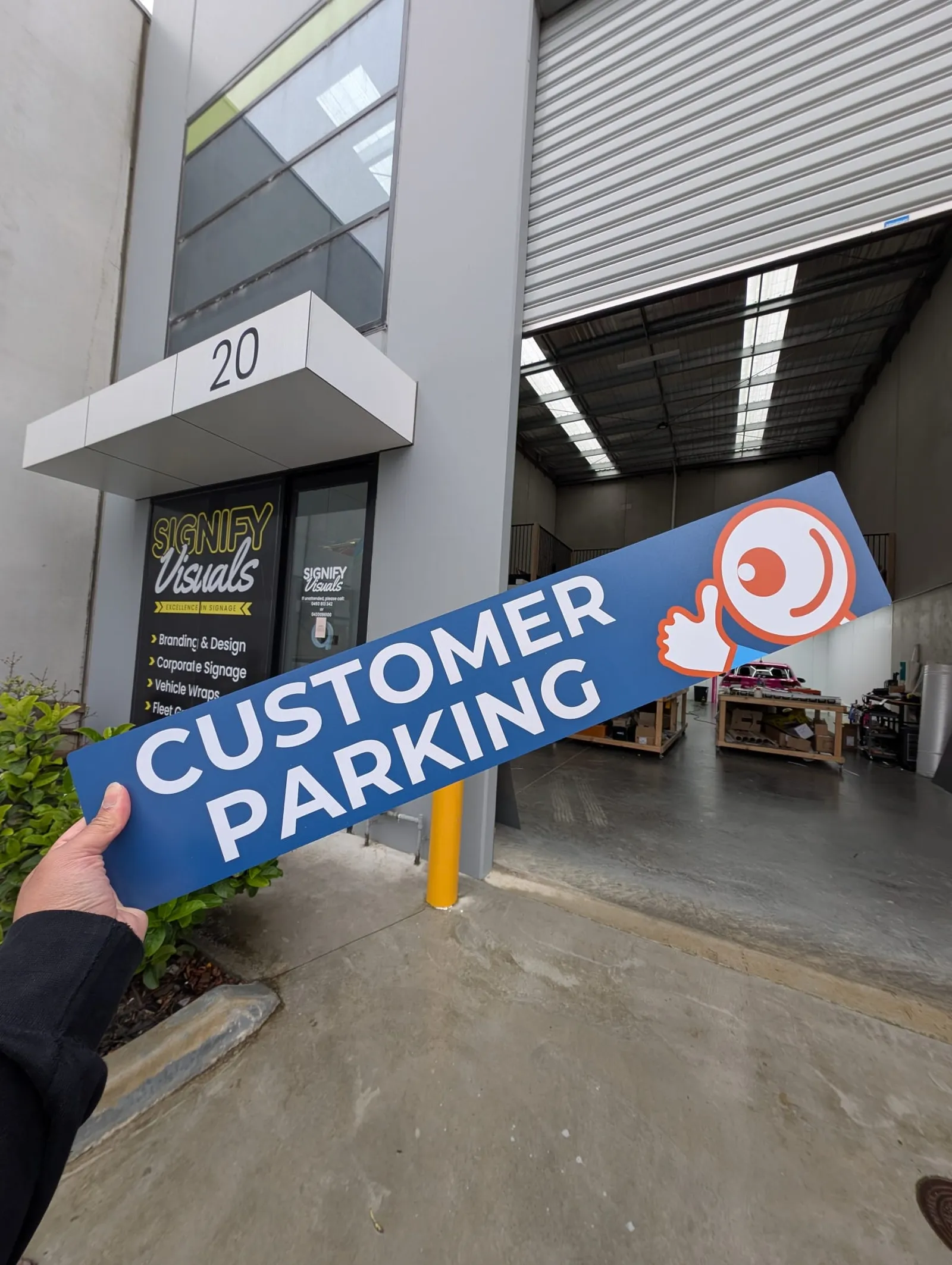 Custom parking wayfinding sign installed at a commercial site